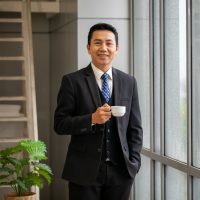 portrait-of-asian-middle-age-businessman-drinking-coffee-at-the-office-smile-businessman-take-a-break_t20_VGRb77